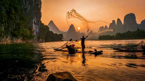 person s on boat throwing fishing net