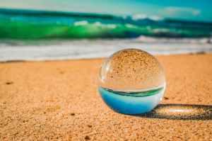 close up photo of crystal ball on sand